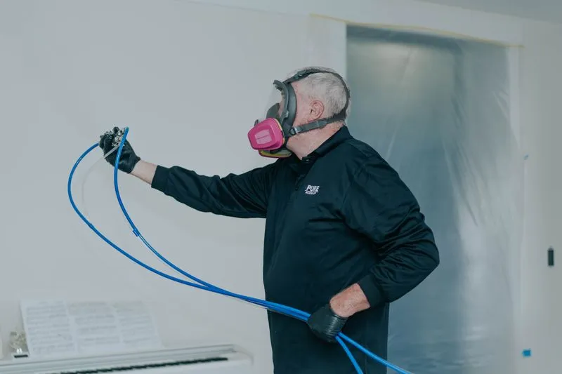 Technician applying antimicrobial protectant